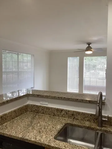 a view of a house with a big yard and potted plants