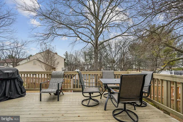 a view of a roof deck with table and chairs and wooden floor