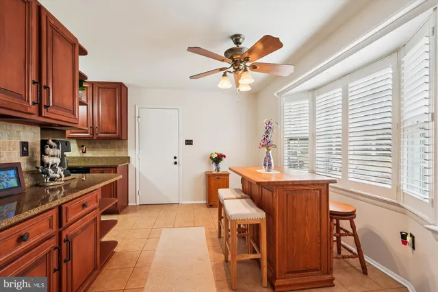 a kitchen with stainless steel appliances granite countertop a stove a sink dishwasher and a refrigerator