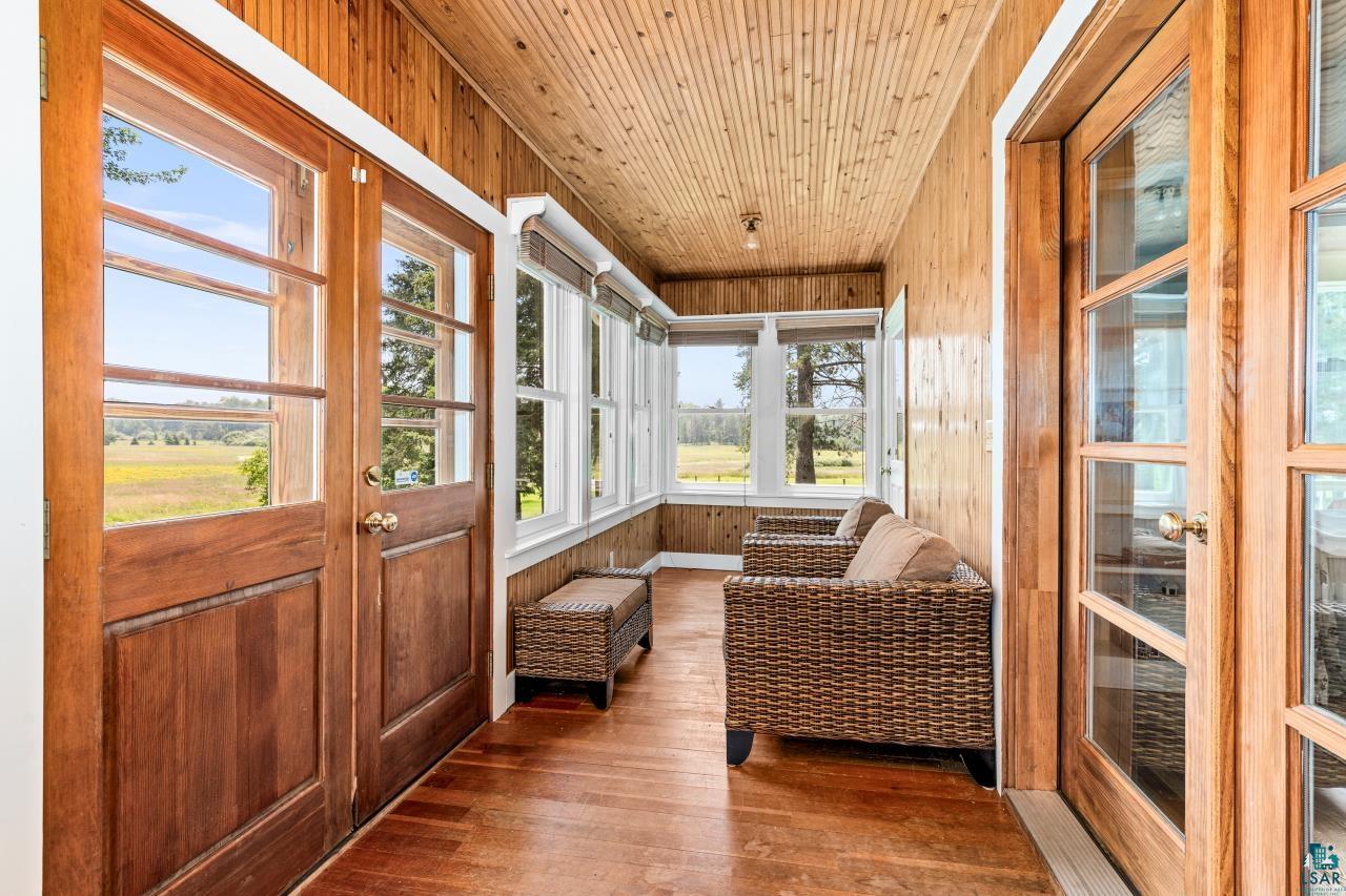33415 Jackson Road Askov, MN 55704 - Photo 27 of 91 Sunroom / solarium featuring wood walls, hardwood / wood-style floors, and wooden ceiling