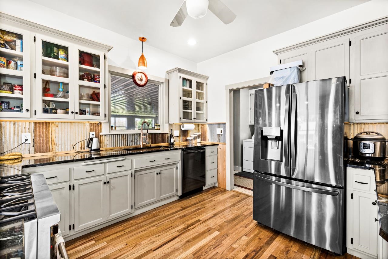 33415 Jackson Road Askov, MN 55704 - Photo 37 of 91 Kitchen featuring stainless steel fridge with ice dispenser, a ceiling fan, stove, light wood-style floors, and decorative backsplash