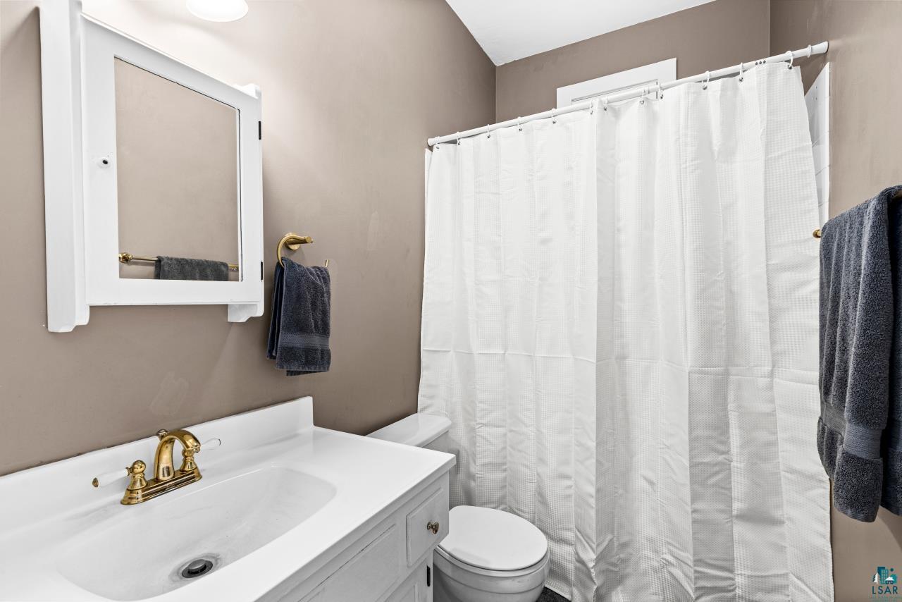 33415 Jackson Road Askov, MN 55704 - Photo 45 of 91 Bathroom with vanity and curtained shower