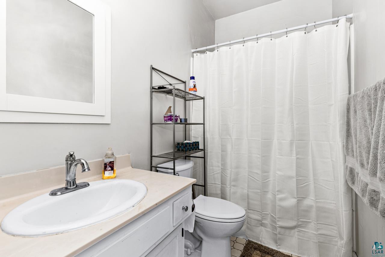 33415 Jackson Road Askov, MN 55704 - Photo 48 of 91 Bathroom featuring vanity and a shower with shower curtain