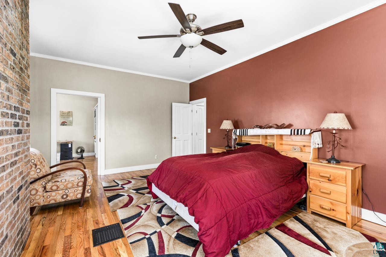 33415 Jackson Road Askov, MN 55704 - Photo 50 of 91 Bedroom featuring wood finished floors, crown molding, and ceiling fan