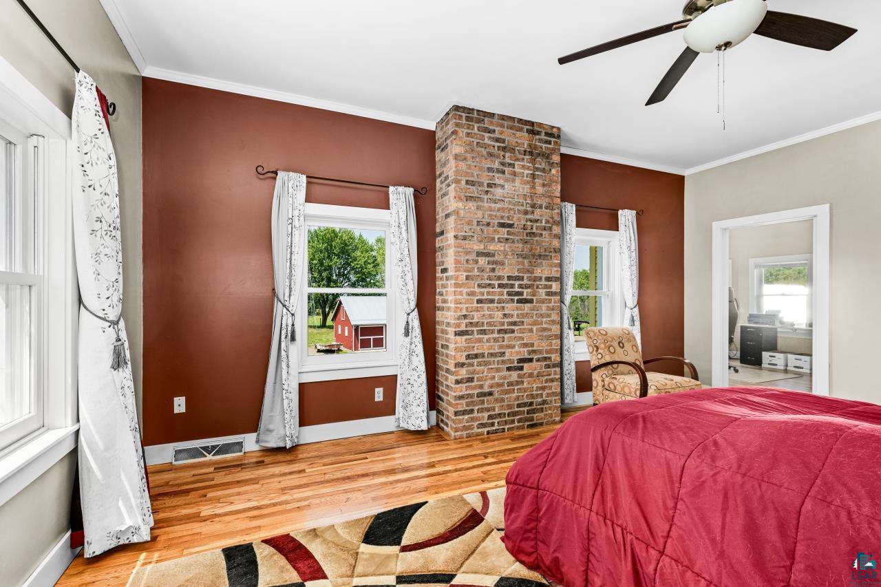 33415 Jackson Road Askov, MN 55704 - Photo 51 of 91 Bedroom featuring wood finished floors, crown molding, and a ceiling fan