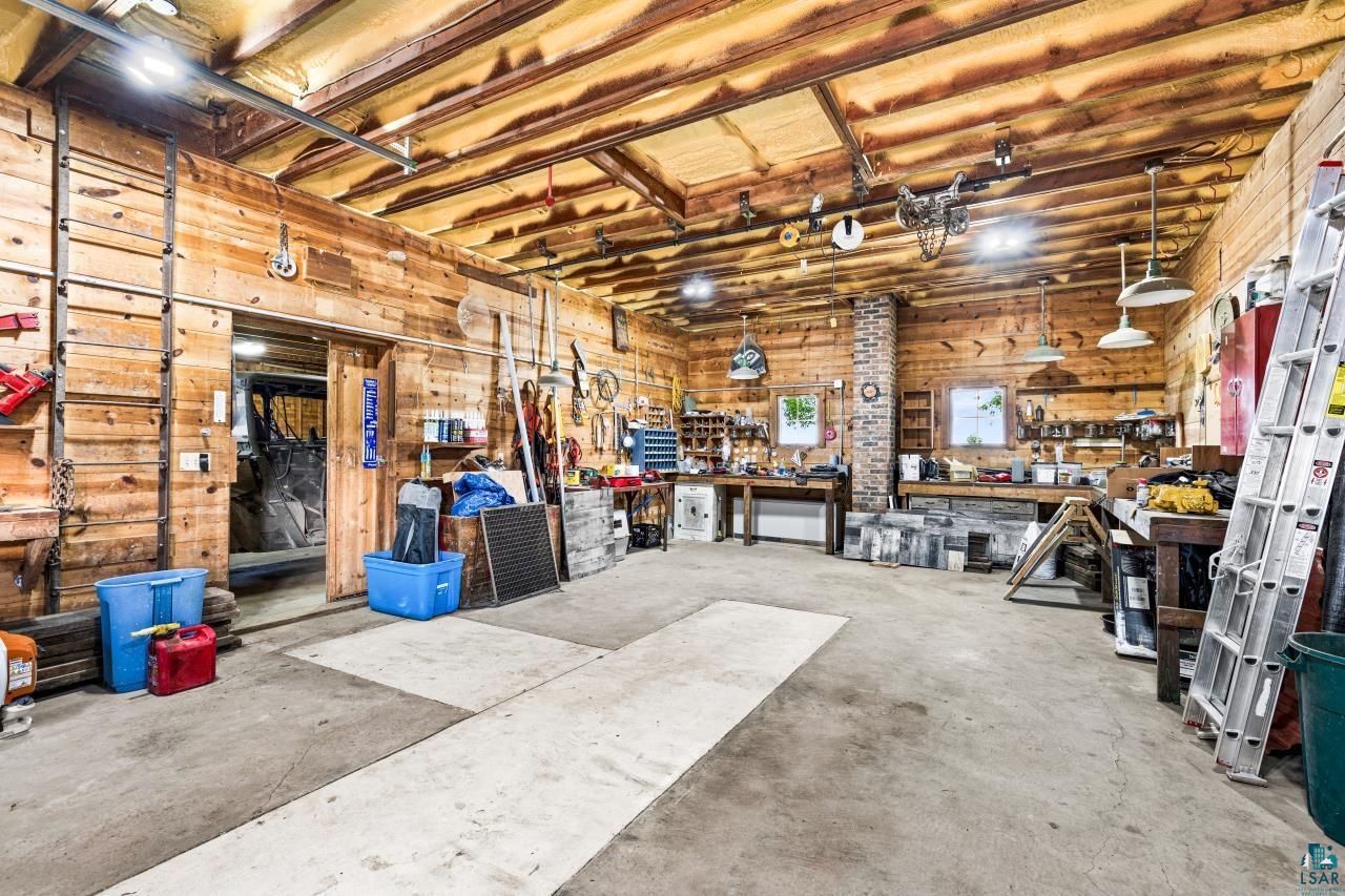 33415 Jackson Road Askov, MN 55704 - Photo 59 of 91 Garage with a workshop area and wood walls