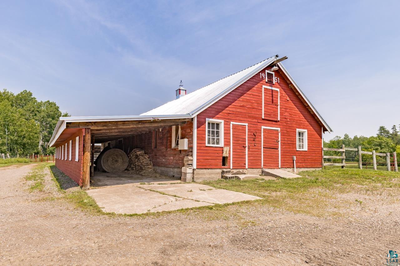 33415 Jackson Road Askov, MN 55704 - Photo 64 of 91 View of side of property featuring a metal roof and an outdoor structure
