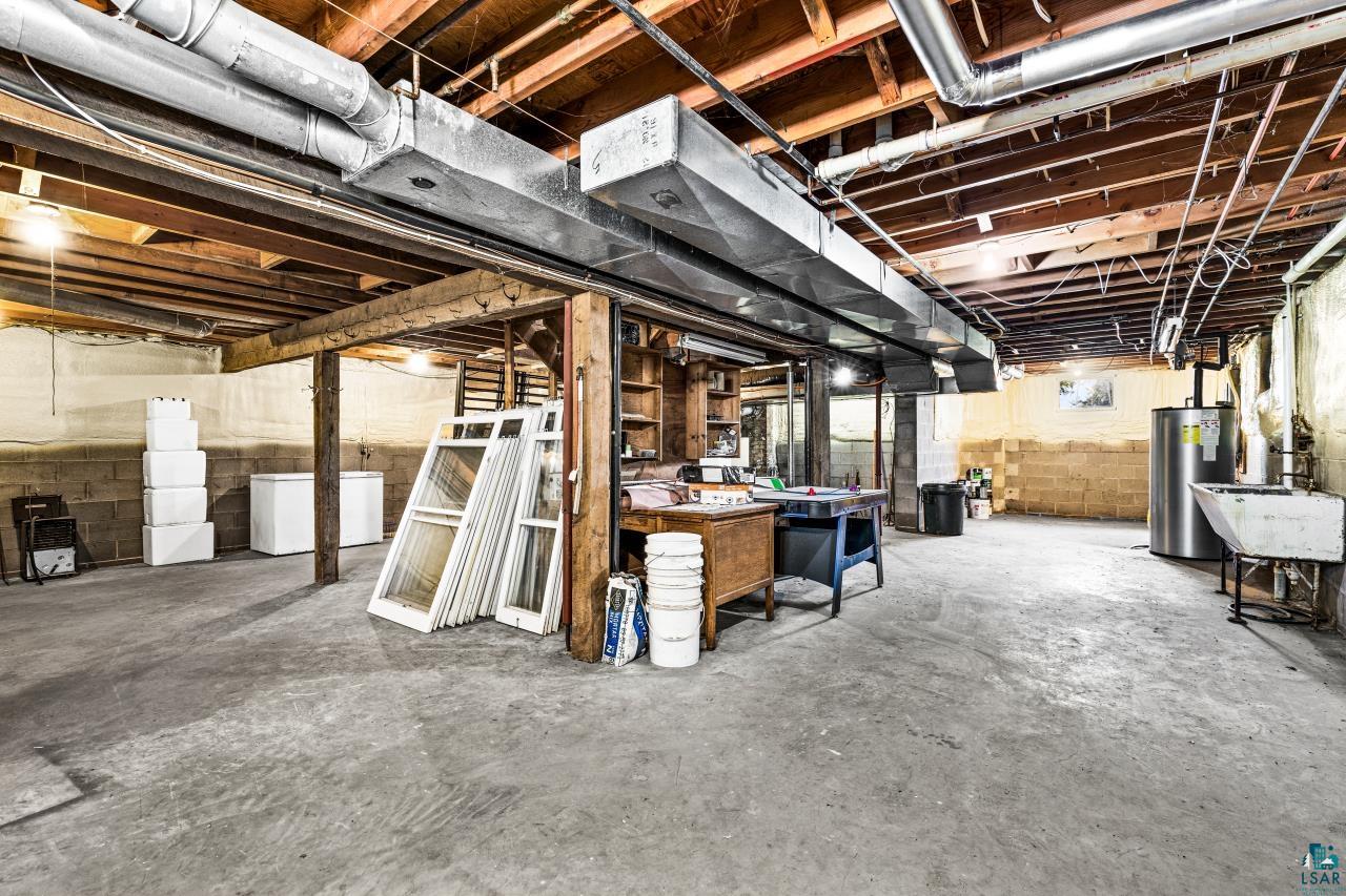 33415 Jackson Road Askov, MN 55704 - Photo 75 of 91 Basement with electric water heater and a sink