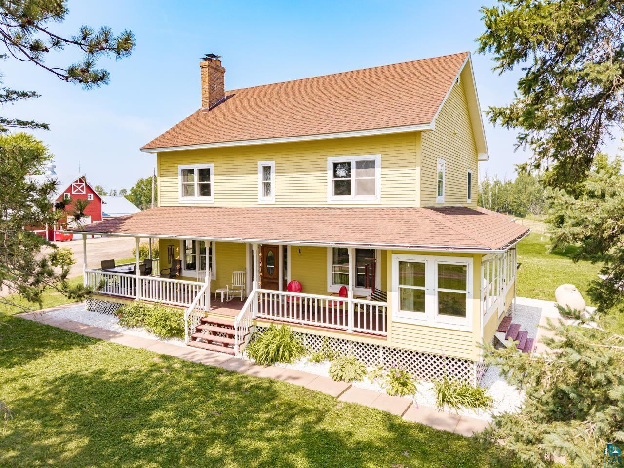 33415 Jackson Road Askov, MN 55704 - Photo 10 of 91 View of front of house with roof with shingles, a chimney, covered porch, and a front yard