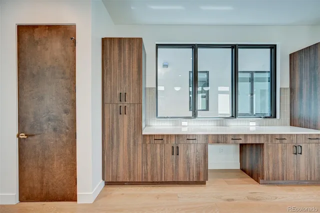 an empty room with windows and closet