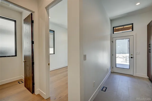 a view of an entryway with wooden floor