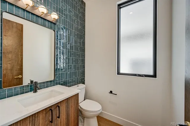 a bathroom with a sink vanity and a mirror
