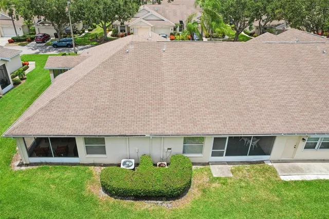 a front view of a house with a yard and potted plants