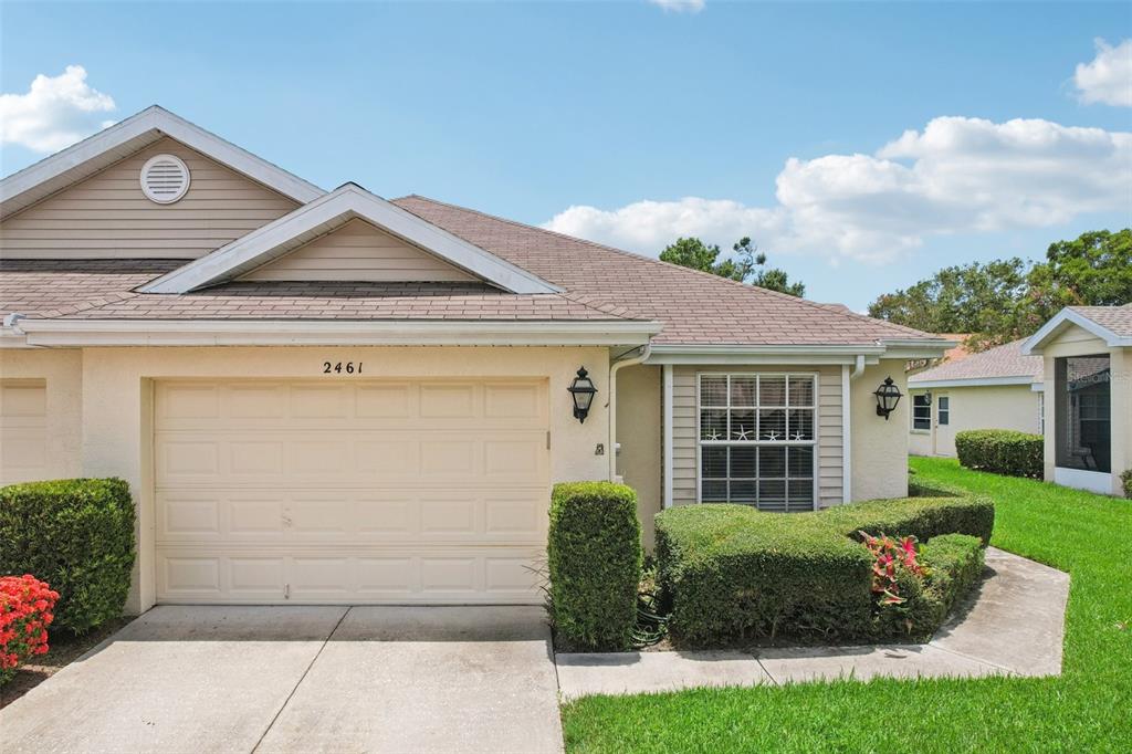 2461 Nantucket Harbor Loop Sun City Center, FL 33573 - Photo 46 of 47 a front view of a house with garden