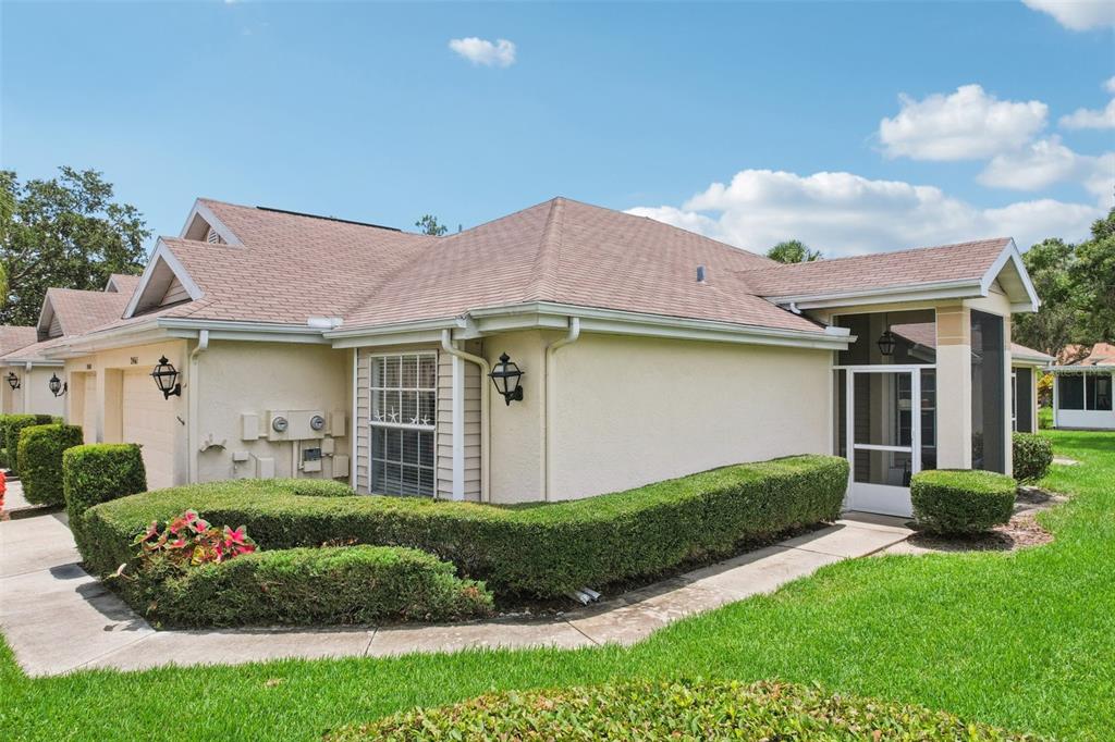 2461 Nantucket Harbor Loop Sun City Center, FL 33573 - Photo 47 of 47 a front view of a house with garden