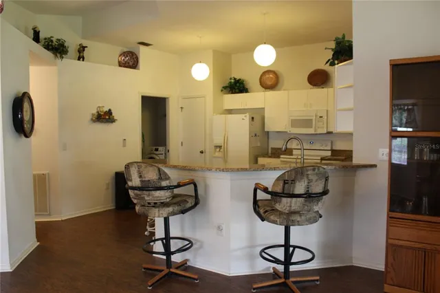 a view of hall way with furniture and chandelier
