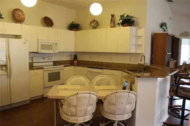 a kitchen with a sink appliances and cabinets