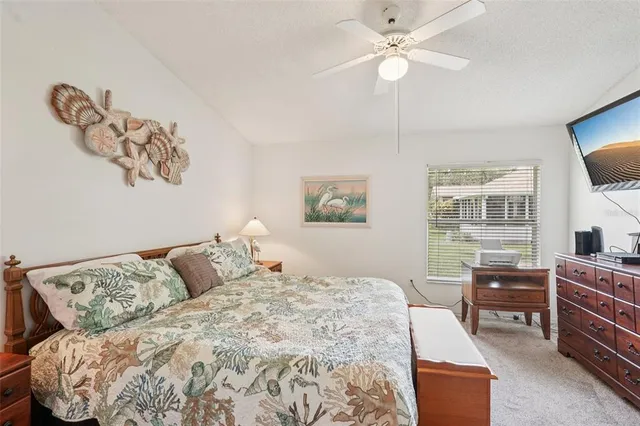 a bedroom with a bed and dresser with mirror