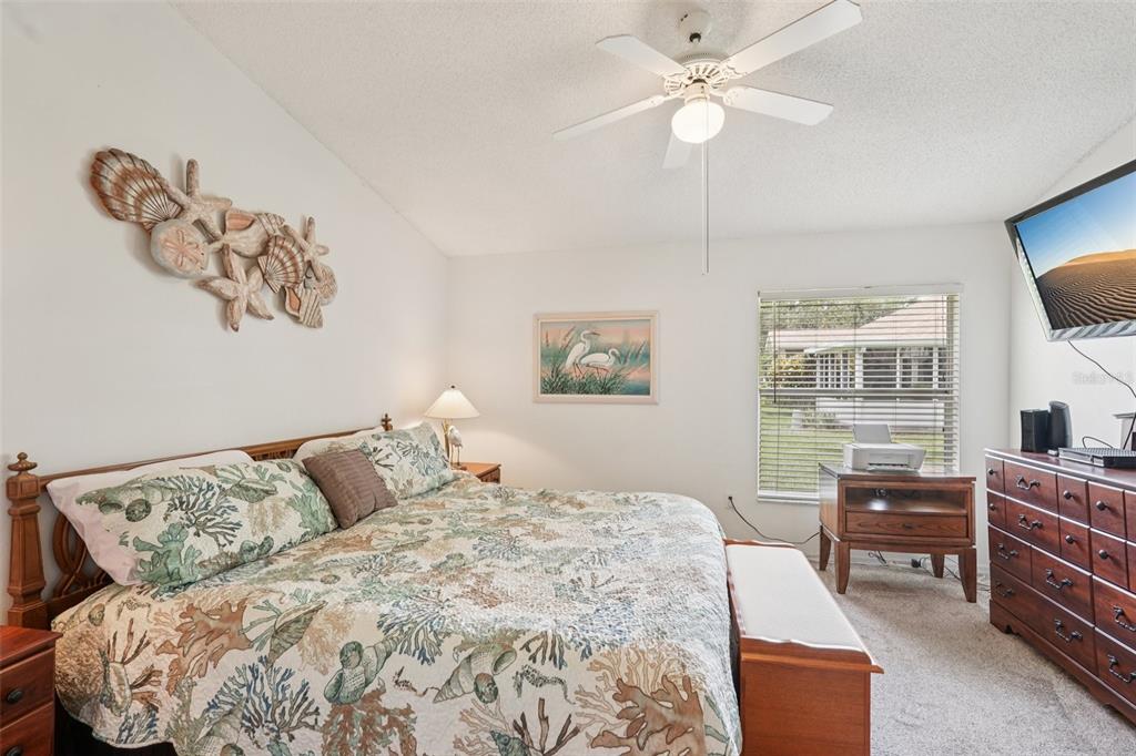 2461 Nantucket Harbor Loop Sun City Center, FL 33573 - Photo 7 of 47 a bedroom with a bed and dresser with mirror