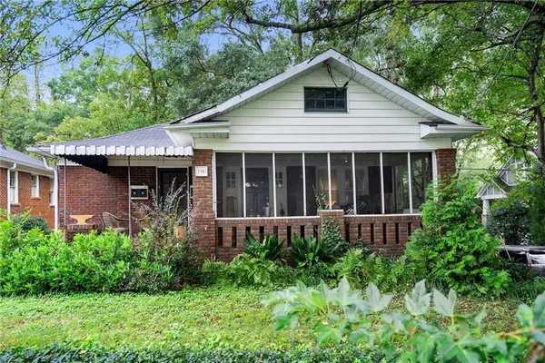 a view of a house with a yard and plants