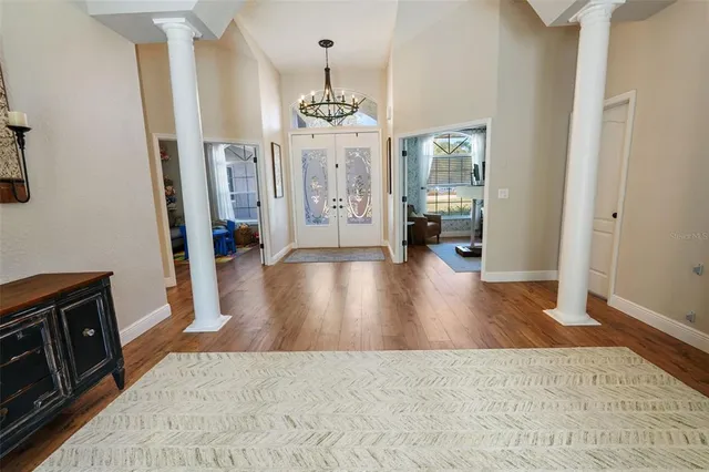 a bedroom with a bed a mirror and dresser