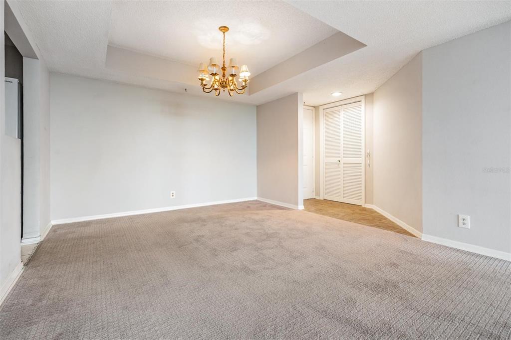 3211 West Swann Avenue, Unit 907 Tampa, FL 33609 - Photo 14 of 32 a view of an empty room with a chandelier