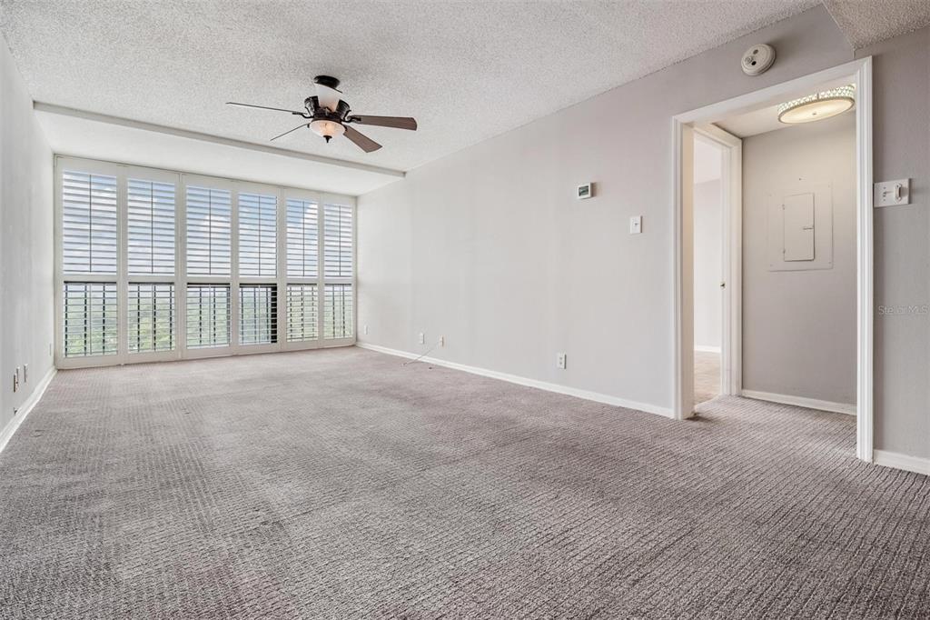 3211 West Swann Avenue, Unit 907 Tampa, FL 33609 - Photo 17 of 32 a view of an empty room with a ceiling fan and window