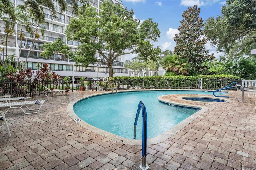 3211 West Swann Avenue, Unit 907 Tampa, FL 33609 - Photo 29 of 32 a view of a swimming pool with a patio and plants