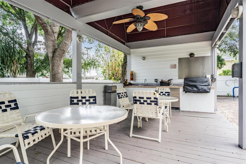 3211 West Swann Avenue, Unit 907 Tampa, FL 33609 - Photo 31 of 32 a dining room with furniture a large window and wooden floor