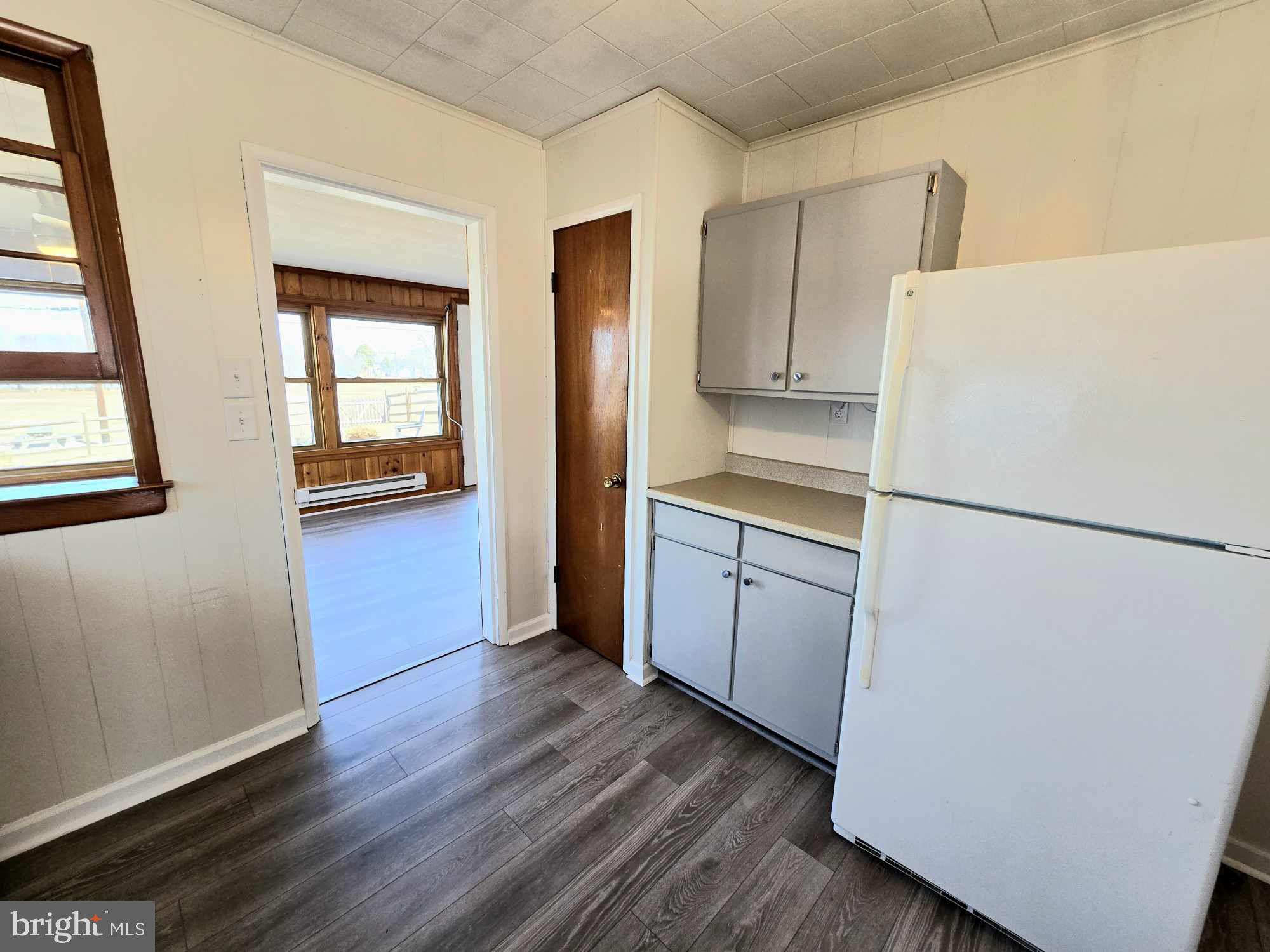 53 Circle Drive Earleville, MD 21919 - Photo 10 of 35 a kitchen with a refrigerator a stove top oven a sink and dishwasher with wooden floor