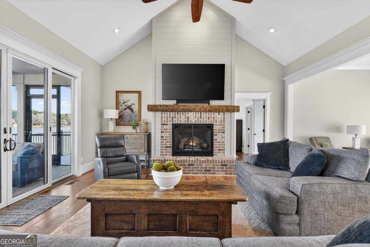 1010 Azalea Lane Buckhead, GA 30625 - Photo 12 of 67 a living room with furniture a flat screen tv and a fireplace
