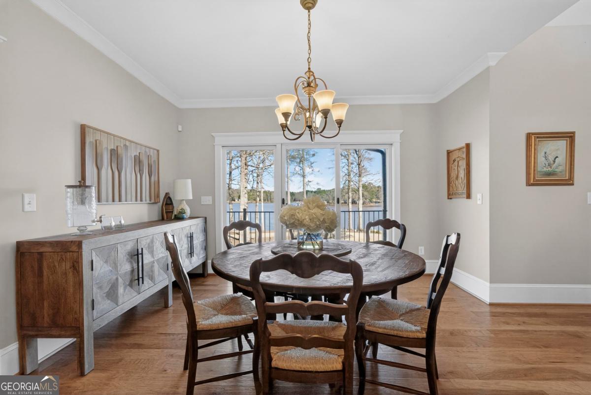 1010 Azalea Lane Buckhead, GA 30625 - Photo 20 of 67 a view of a dining room with furniture a chandelier and wooden floor