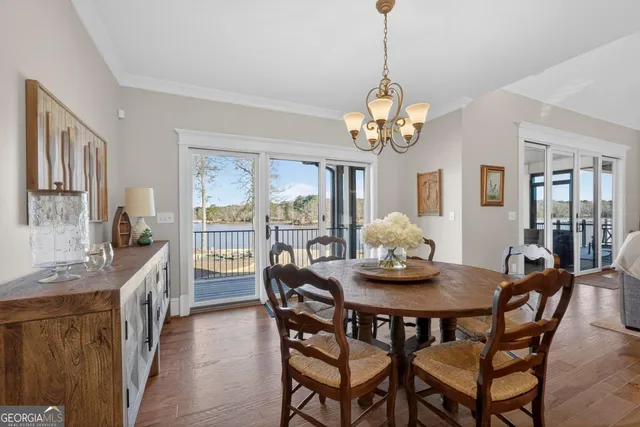 a kitchen with stainless steel appliances granite countertop a sink a stove a refrigerator cabinets and wooden floor