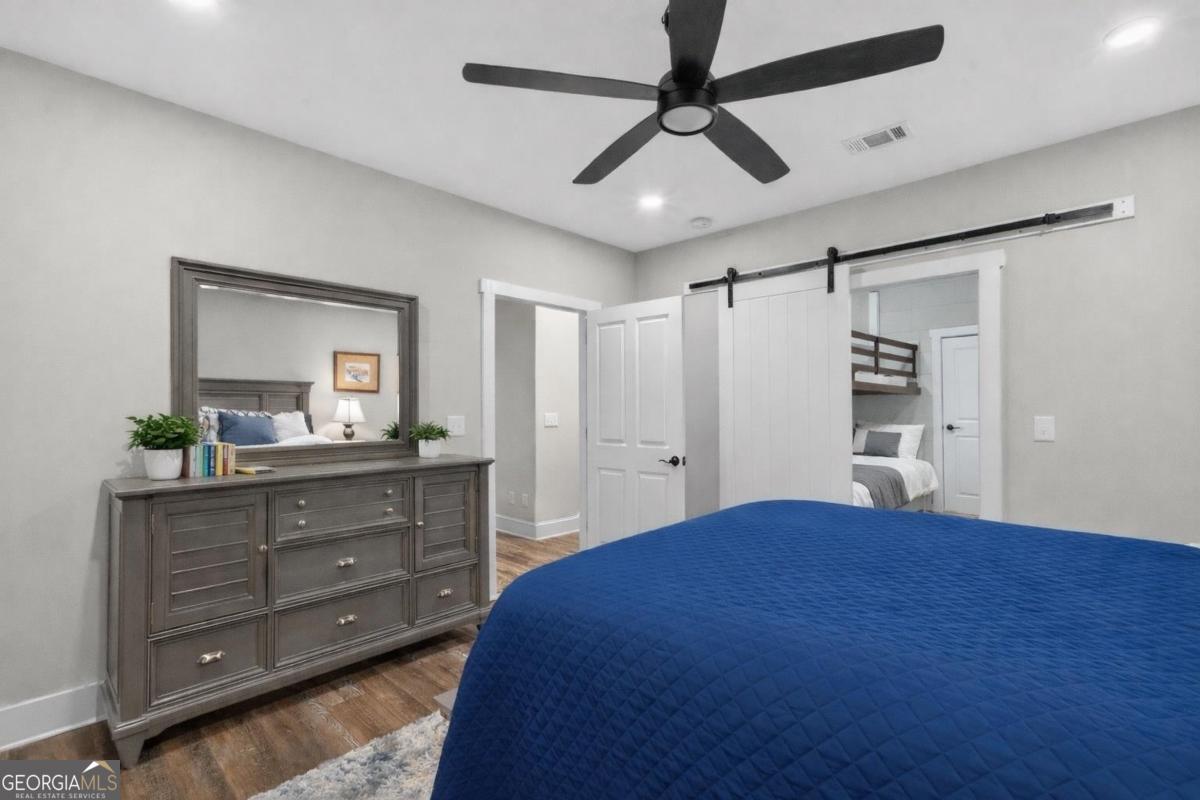 1010 Azalea Lane Buckhead, GA 30625 - Photo 46 of 67 a bedroom with a large bed and a chandelier