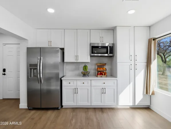 a large kitchen with stainless steel appliances granite countertop a large center island and a stove