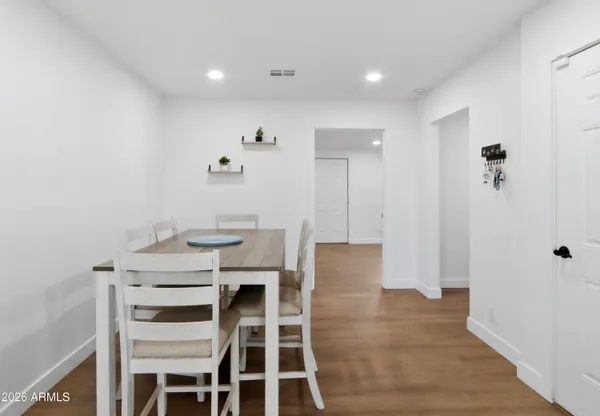 a kitchen with white cabinets and sink