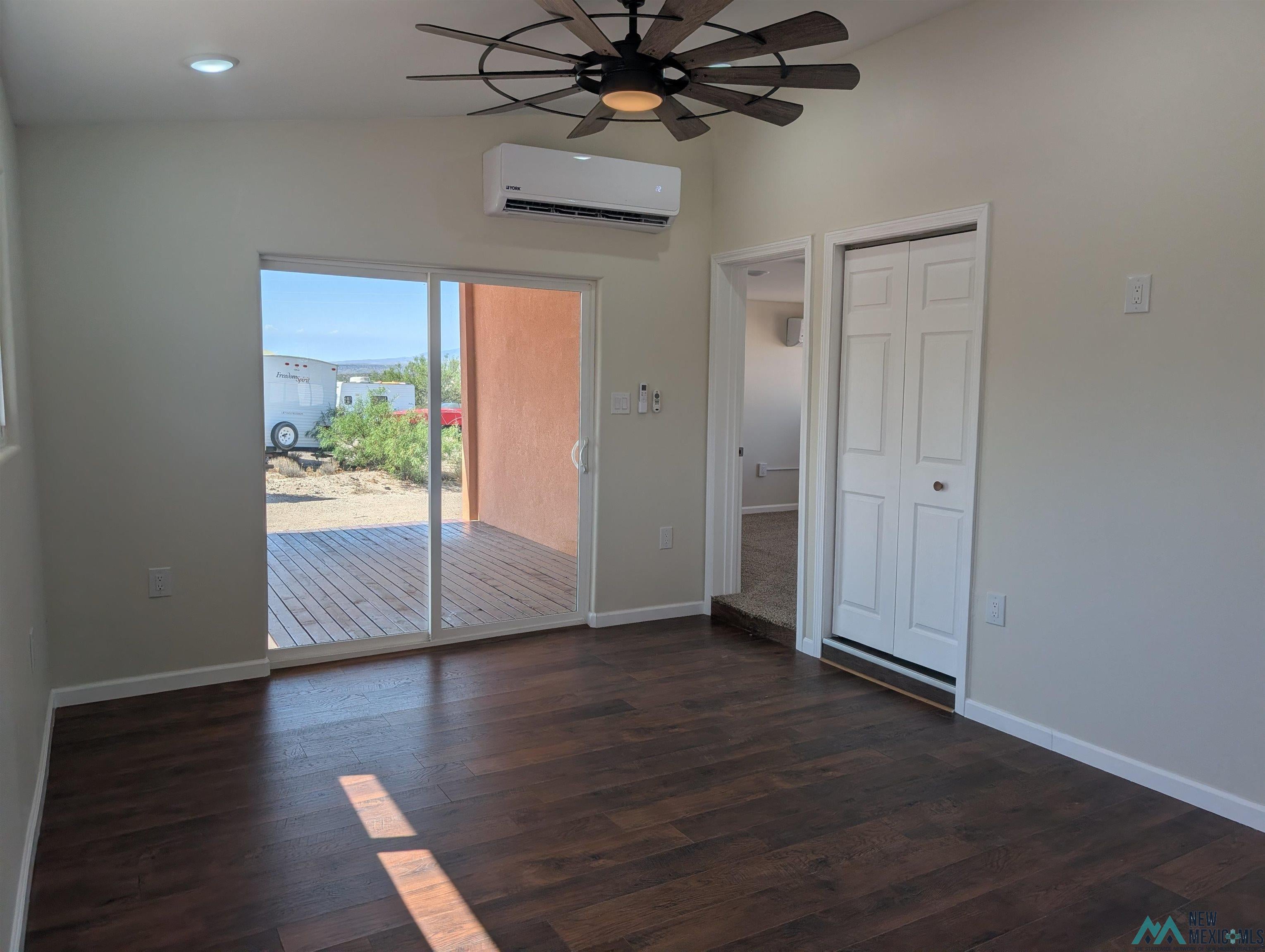 506 Bass Road Elephant Butte, NM 87935 - Photo 10 of 23 Wood-finish flooring, white baseboards, and neutral wall paint