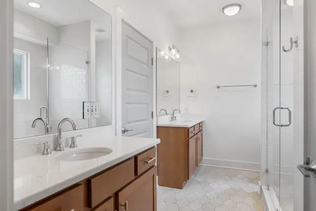 a bathroom with a double vanity sink mirror and double