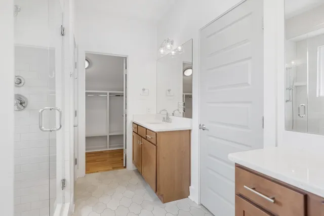 a bathroom with a shower sink and mirror