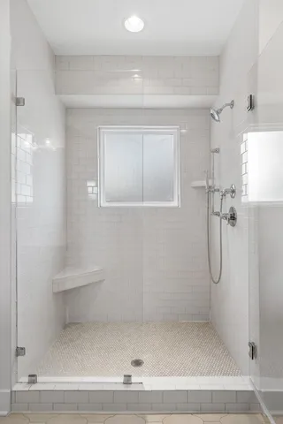 a bathroom with a glass shower door
