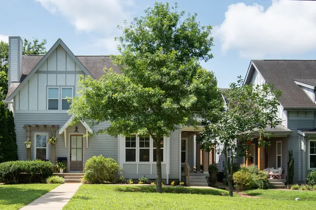 an aerial view of a house with a yard and plants