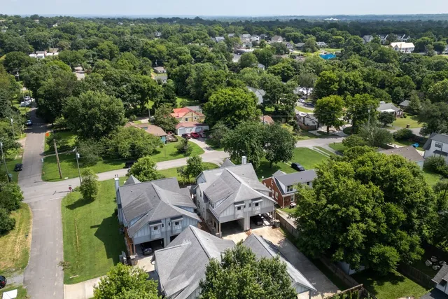 a view of a house with a yard and a garden
