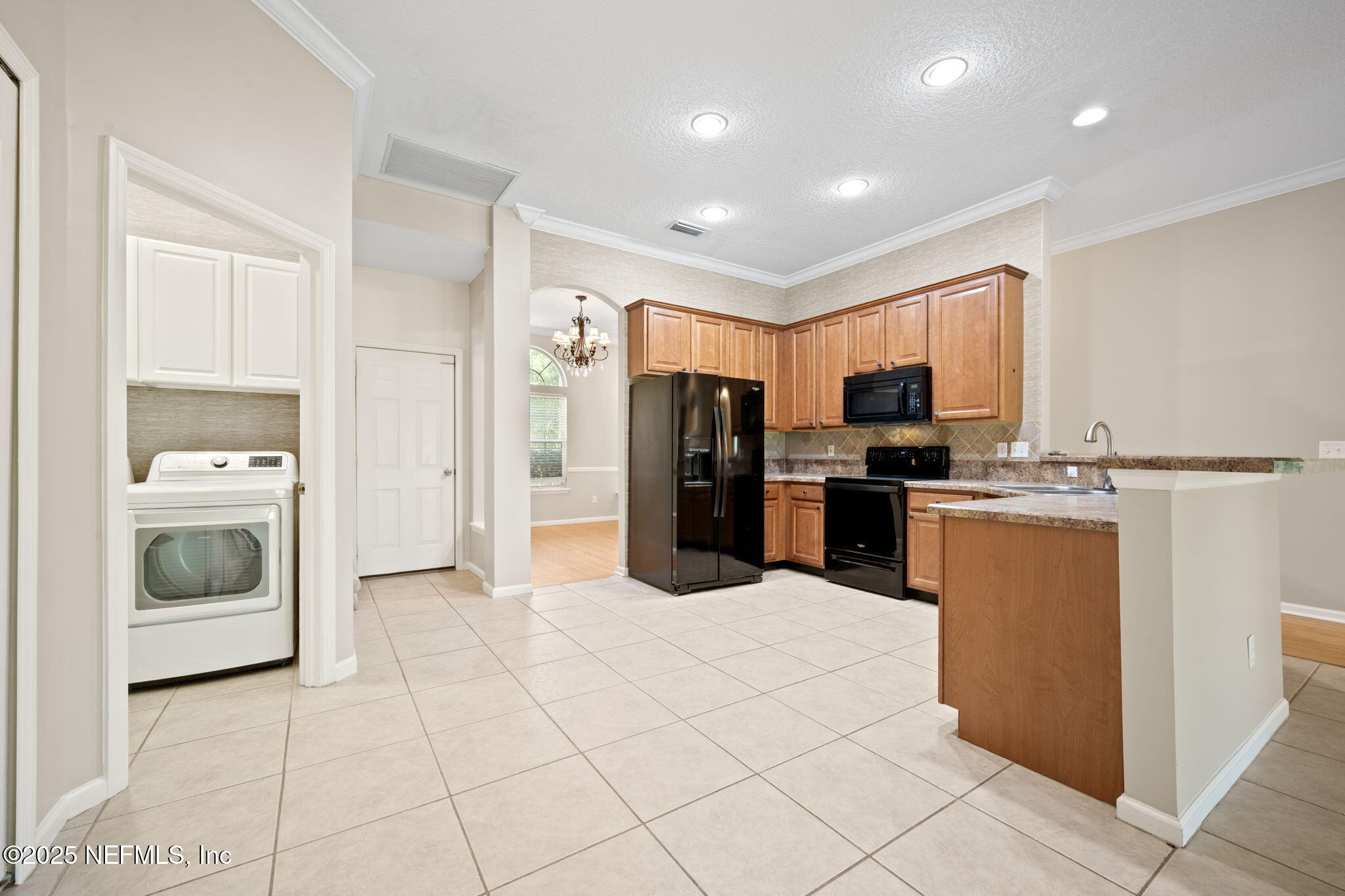 96316 Ridgewood Circle Fernandina Beach, FL 32034 - Photo 11 of 32 a kitchen with granite countertop a refrigerator and a stove top oven