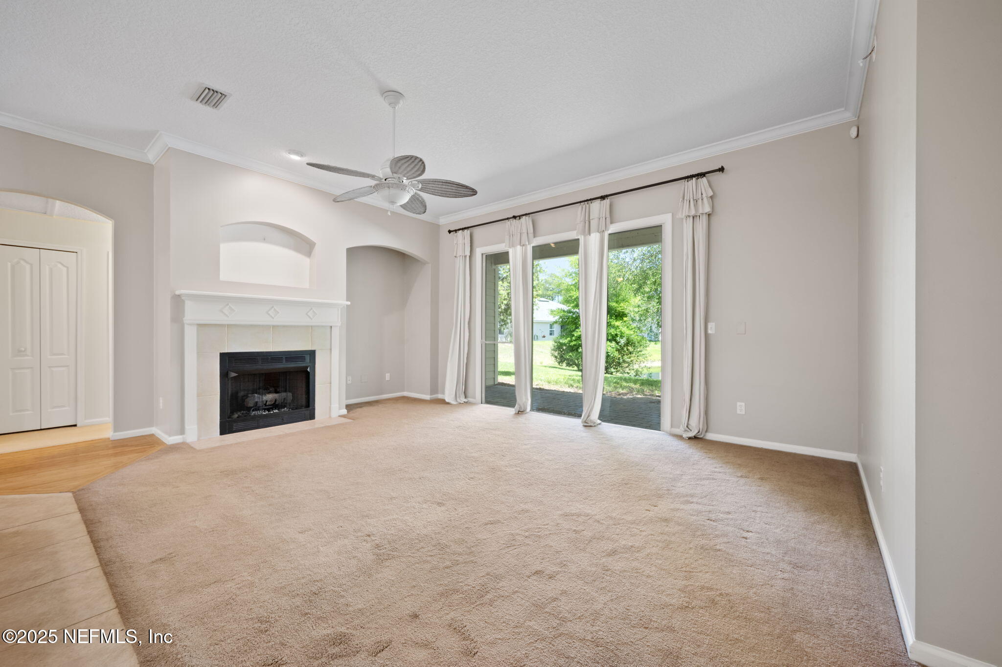 96316 Ridgewood Circle Fernandina Beach, FL 32034 - Photo 12 of 32 a view of an empty room with a fireplace and a window