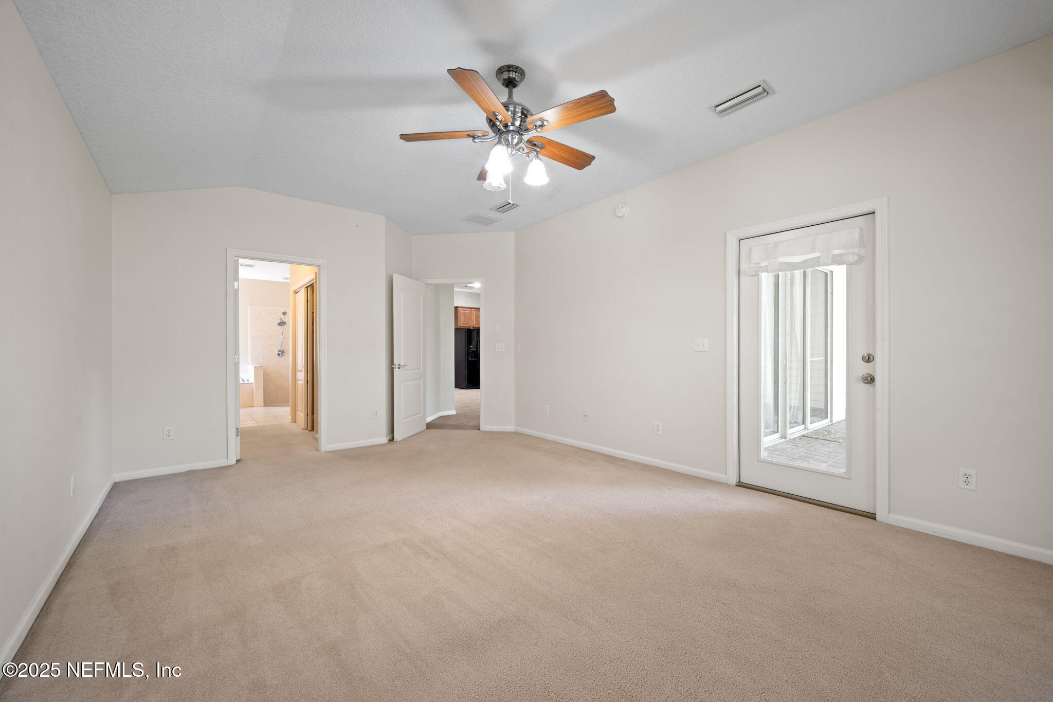96316 Ridgewood Circle Fernandina Beach, FL 32034 - Photo 16 of 32 a view of an empty room with a ceiling fan