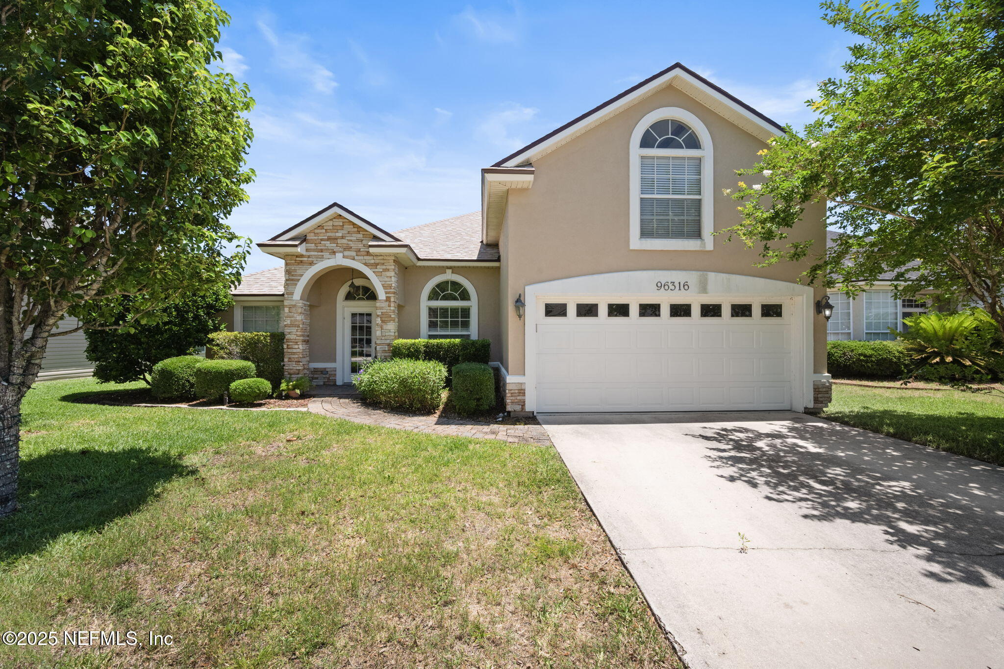 96316 Ridgewood Circle Fernandina Beach, FL 32034 - Photo 2 of 32 a view of a house with a yard and a large tree