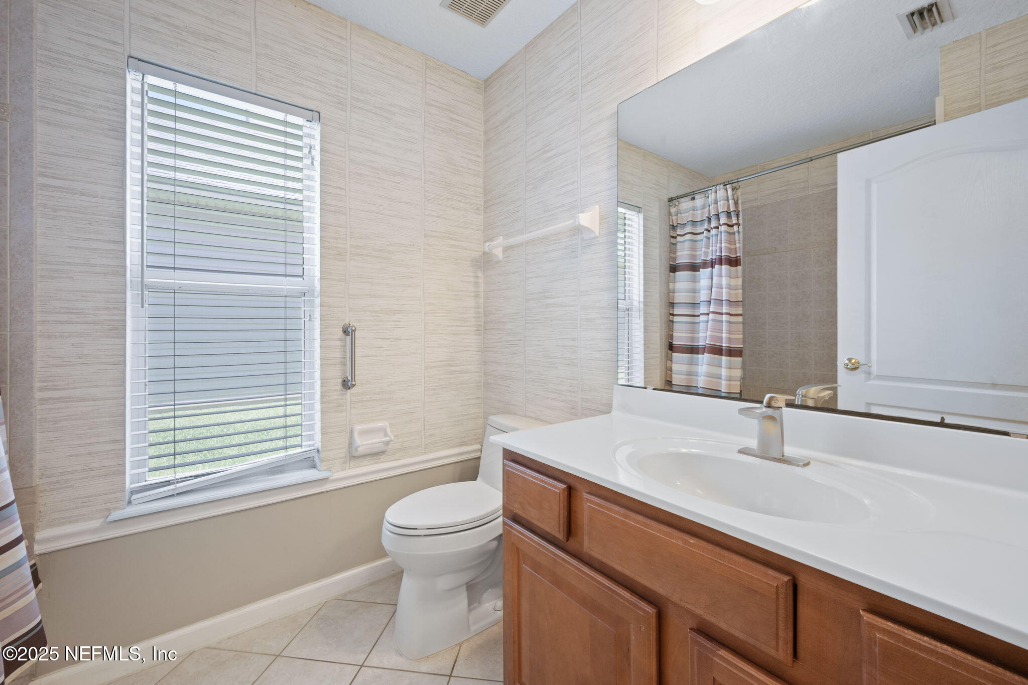 96316 Ridgewood Circle Fernandina Beach, FL 32034 - Photo 23 of 32 a bathroom with a sink toilet a mirror and shower