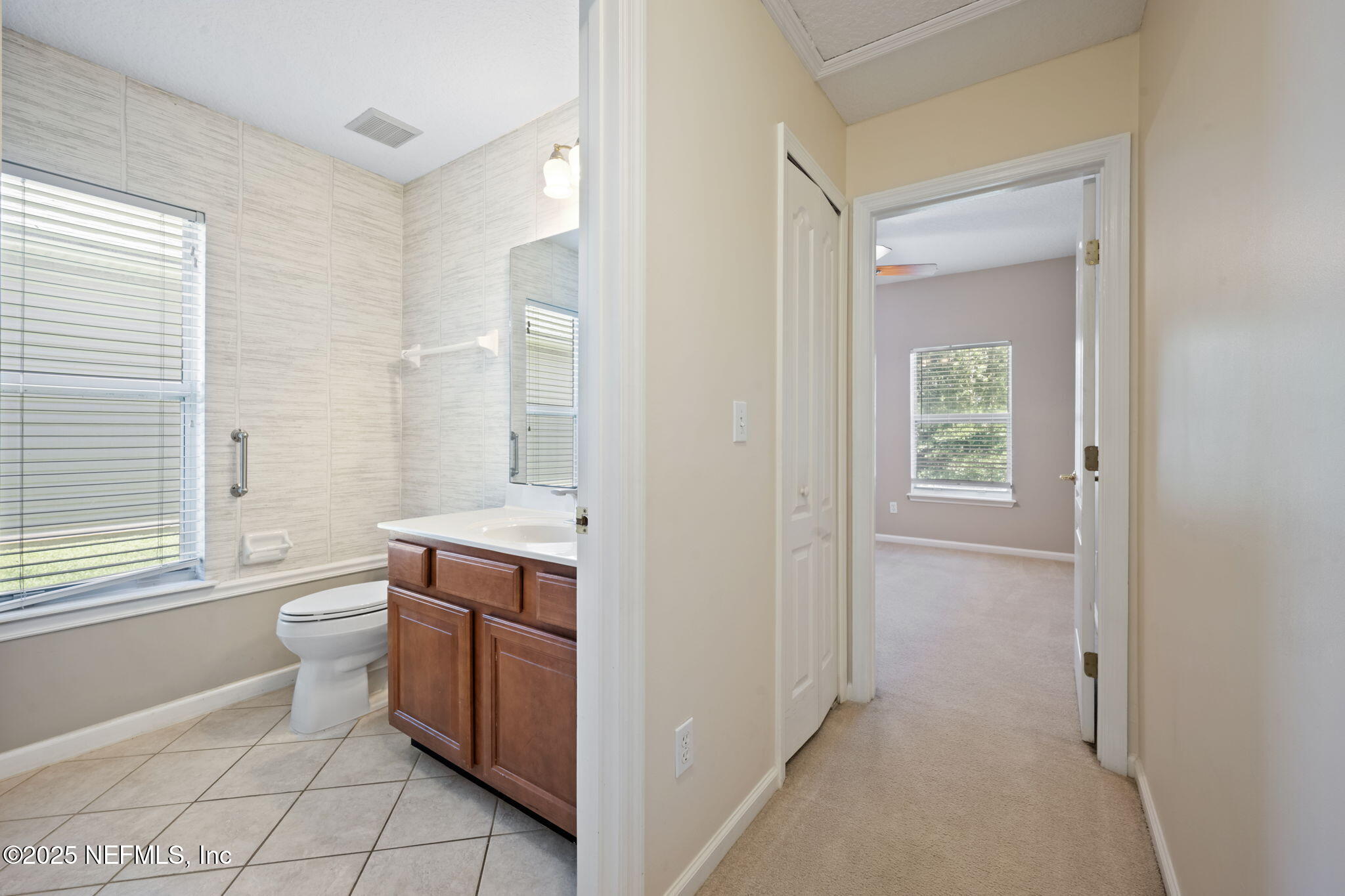 96316 Ridgewood Circle Fernandina Beach, FL 32034 - Photo 24 of 32 a bathroom with a granite countertop toilet a sink and a mirror