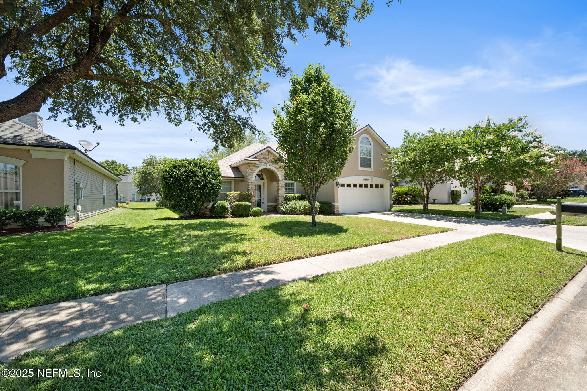 96316 Ridgewood Circle Fernandina Beach, FL 32034 - Photo 3 of 32 a view of a house with a big yard plants and large trees