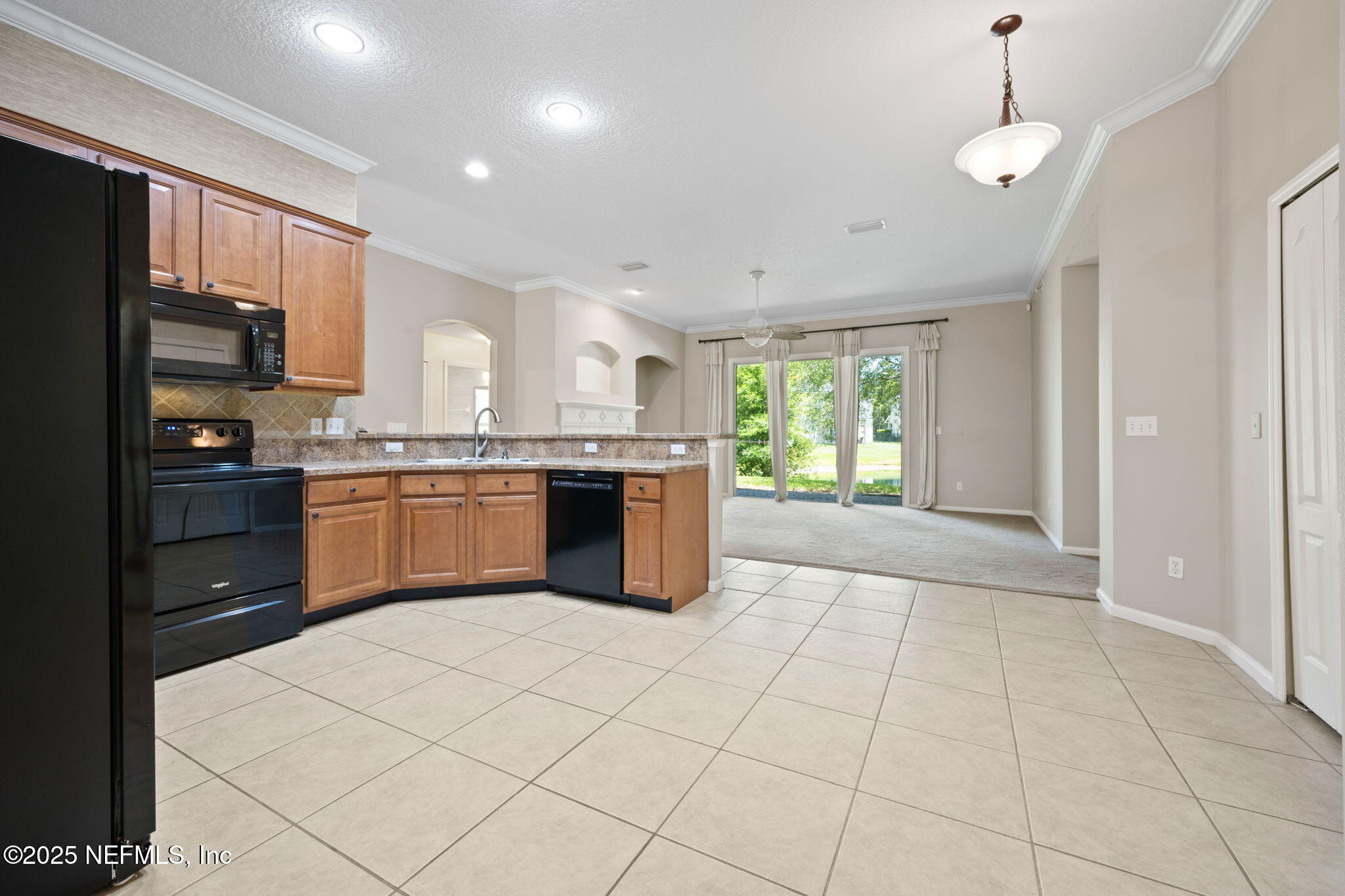 96316 Ridgewood Circle Fernandina Beach, FL 32034 - Photo 10 of 32 a kitchen with stainless steel appliances granite countertop a stove top oven a sink dishwasher and a refrigerator with wooden floor